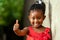 Pretty little african girl showing thumbs up.