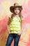 Pretty little girl with cute face in western cowboy hat