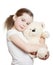 The pretty little girl embraces a teddy bear