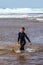 pretty little girl enjoying surfing the waves with a bodyboard during her vacation