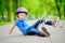 Pretty little girl learning to skateboard outdoors