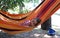 Pretty little girl resting in the hammock in the resort