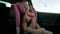 Pretty little girl sleeping in car seat during ride in backseat