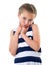 Pretty little girl in striped dress studio portrait, making a surprised face, white background