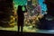 pretty little girl taking pictures of tropical fish in a giant aquarium