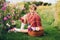 Pretty little kid girl playing outside in flower garden