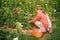 Pretty little kid girl playing outside in flower garden