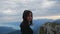 Pretty long hair hiker girl looking at epic view at Schafberg mountain in Salzkammergut Austria.