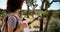 Pretty lost traveler looking at tablet computer in Joshua Tree.