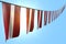 Pretty many Latvia flags or banners hangs diagonal on rope on blue sky background with soft focus - any occasion flag 3d