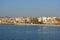 Pretty Mediterranean town and beach from the sea, early morning