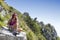 Pretty middle aged female hiker resting on big rock