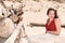 Pretty middle aged woman on a tropical beach with wooden driftwood