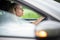 Pretty midle aged woman at the steering wheel of her car