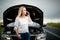 Pretty midle aged woman at the steering wheel of her car