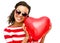 Pretty mixed race girl holding red heart balloon