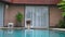 Pretty model in a sky-blue swimsuit dives head foremost into the pool in the backyard of a luxury house, summer leisure