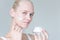 Pretty model woman applying anti aging face cream. Skincare advertisement