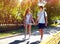 Pretty modern young couple in love walking in sunny summer day