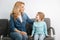 Pretty mom sitting in the hall with her daughter