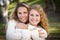 Pretty Mother and Daughter Portrait in Park