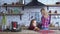 Pretty mother in plaid shirt with long blond hair cooking breakfast and little girl bite one cookie