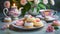 A pretty Mothers\\\' Day or Easter high tea with flowers, delicious petit-four biscuits