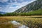 Pretty mountain lake with reflections of trees and hills. Calm and serene