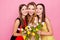 Pretty, nice trio of girls in dresses, having colorful tulips in