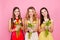 Pretty, nice trio of girls in dresses, having colorful tulips in