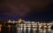 Pretty night time illuminations of Prague Castle, Charles Bridge and St Vitus Cathedral reflected in the Vltava river