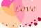 Pretty pastel colored hearts with the word LOVE in raised gold lettering