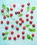 Pretty pattern made of sweet cherry with green leaves on light blue shabby chic background