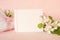 Pretty Peachy Pink Banner with Blank card and fresh spring apple blossoms with wrapped gift for Mothers Day, birthday or girl Baby