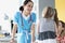 Pretty pediatrician chatting with cute patient child girl on appointment in clinic