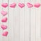 Pretty Pink Valentines Day hearts on White wood Boards Background with a Shabby Chic Style.  It`s a square with copy space in the