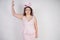 Pretty plump woman in pink dress with patent leather stiletto heels on white background in Studio