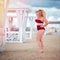 Pretty plus size, curvy woman posing on the beach during summer vacation