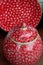 Pretty red dish and lidded pot with white pattern across glossy surface