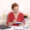 Pretty red haired Woman working in Home Office