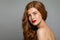 Pretty redhead woman face. Red head girl with curly hairstyle. Ginger hair, red lips makeup