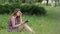 Pretty relaxed adult woman reading a book at the park