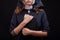 Pretty religious nun in religion concept against dark background.