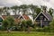 Pretty rural buildings with wooden bridge and trees. Idyllic countryside landscape. Typical holland houses with vintage bridge.