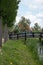 Pretty rural buildings with wooden bridge and trees. Idyllic countryside landscape. Typical holland houses with vintage bridge.