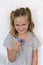 Pretty seven-year-old girl playing with toy hand spinner