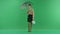 Pretty shopping woman is standing with shopping bags and umbrella. Female shopper holding shopping bags front on green