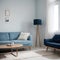 Pretty simple decor of living room with blue sofa and light blue wall