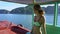 Pretty Slim Blond Girl in Swimsuit Travels on Traditional Boat