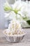 Pretty small cupcakes, lavishly decorated, on wooden table